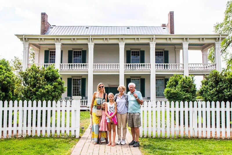 people standing in front of a house