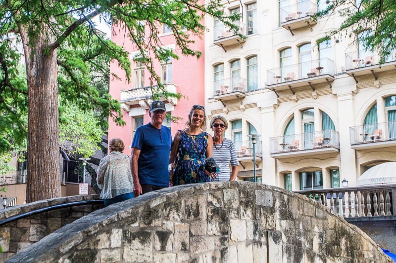 family posing on arched bridge san antonio-river walk texas