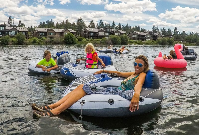 family on tubes on river