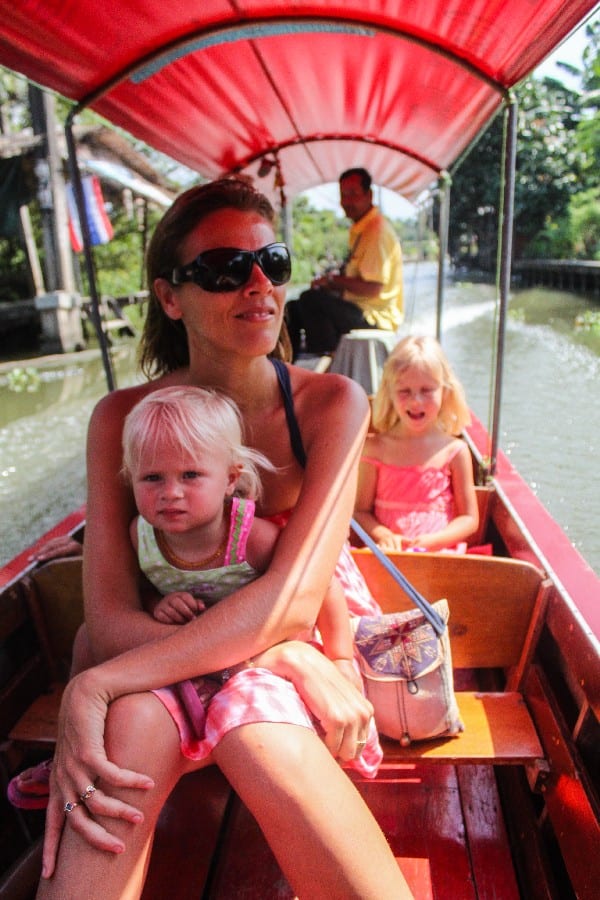 woman holding a child on a canoe