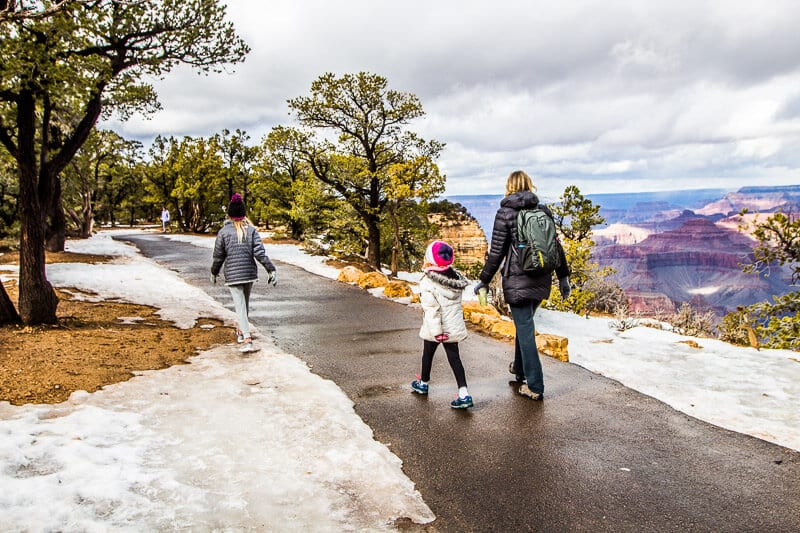 family walking on paved south rim trail at grand canyon