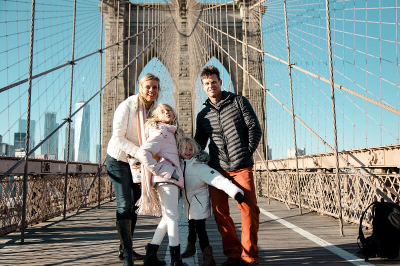 family posing on the Brooklyn Bridge 