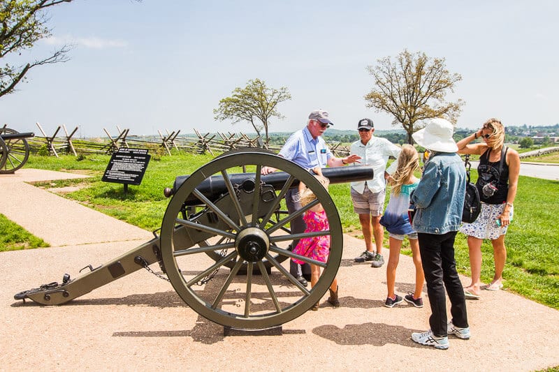 family on tour looking at cannon at  Gettysburg