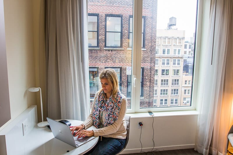 woman at desk in hotel room at innside new york