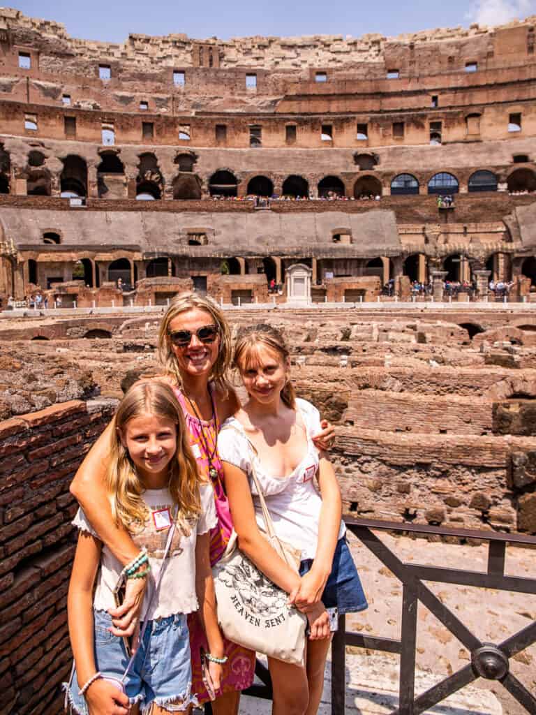 caz and the girls smiling at camera inside colosseum