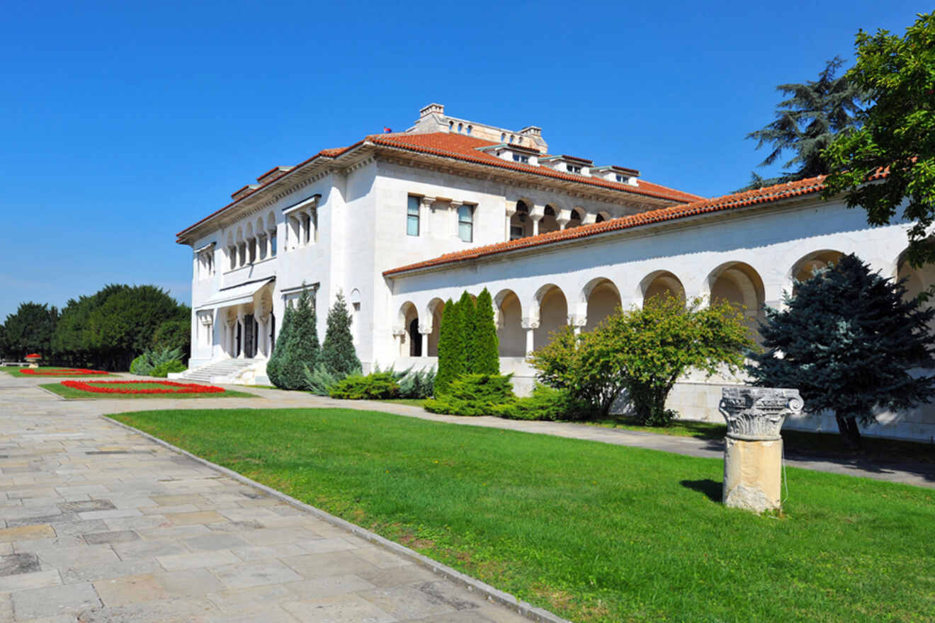 Beli Dvor, the royal palace in Belgrade, presented in bright daylight, highlighting its elegant white facade and red-tiled roof amidst well-kept gardens