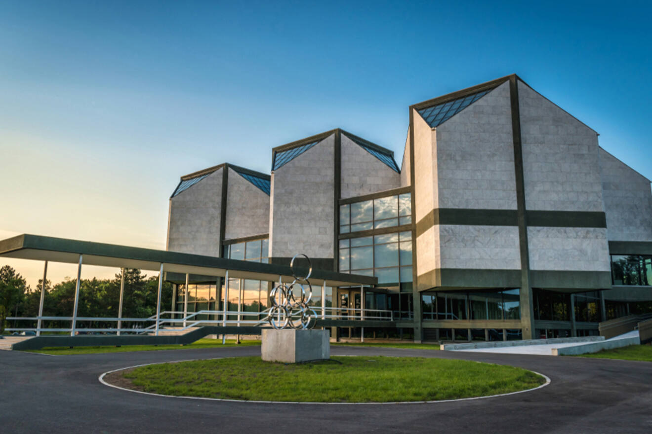 The Museum of Contemporary Art in Belgrade, captured in bright sunlight, features its distinctive angular architecture and reflective glass windows