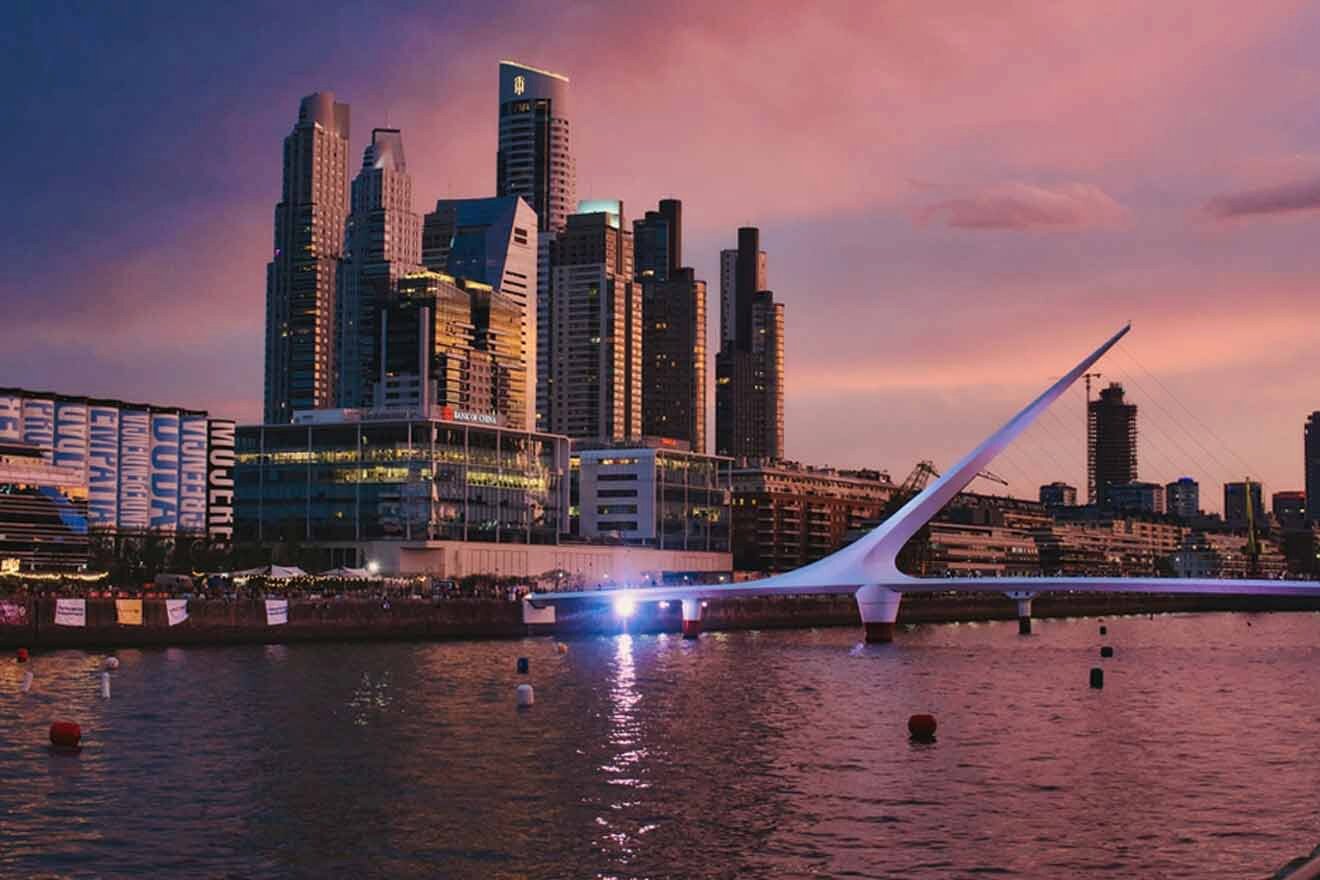 The skyline of a Buenos Aires at dusk with a bridge in the background.