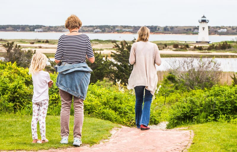 people walking down a hill