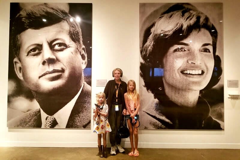 woman and children posing in front of jfk mural at JFK Museum, Dallas