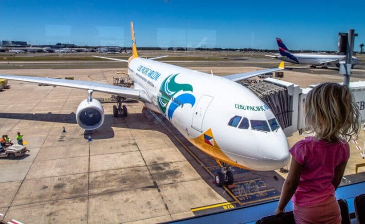 young girl looking at plane