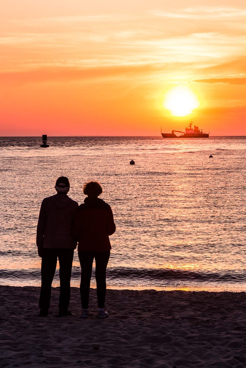 Silhouette of couple in front of  the beautiful sunset in Menemsha in Martha's Vineyard, Massachusetts