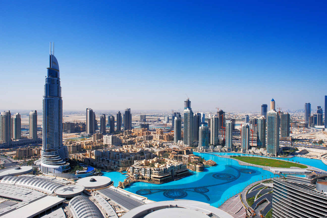 Panoramic daytime view of Downtown Dubai showing the Address Hotel, Dubai Fountain, and surrounding skyscrapers
