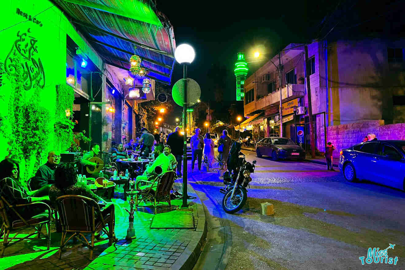 Nightlife on Rainbow Street in Amman, Jordan, with glowing street lights, busy traffic, and people enjoying the urban evening atmosphere