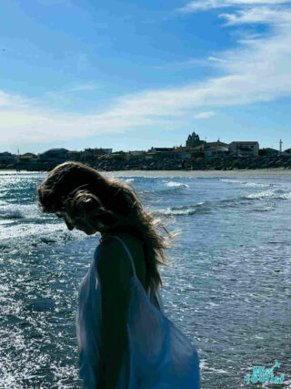 The writer of the post gazes at the sparkling Mediterranean Sea from the sandy shores of Saintes-Maries-de-la-Mer, France