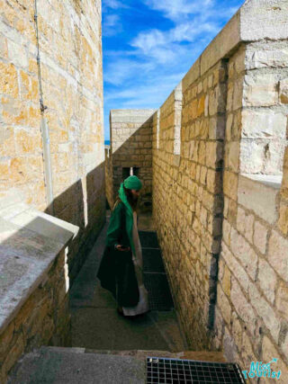 The writer of the post explores the narrow, sunlit corridors between ancient stone walls in Saintes-Maries-de-la-Mer, France