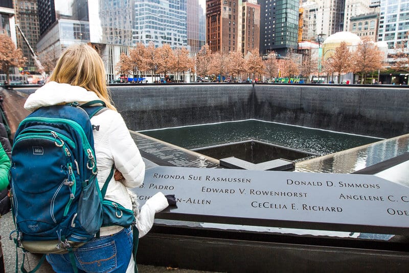 woman looking at World Trade Center Memorial, NYC