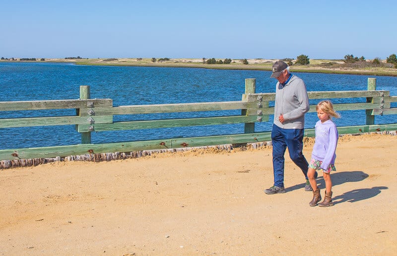 grandfather and granddaughter walking together