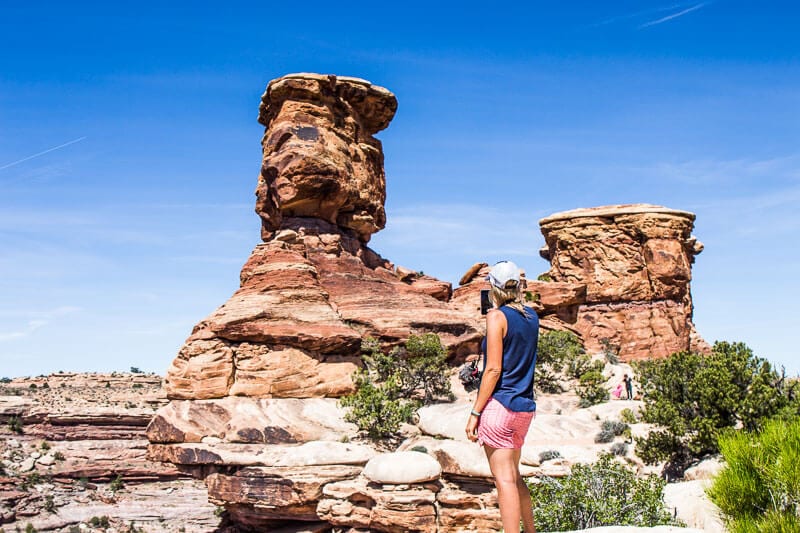 woman looking at a large rock