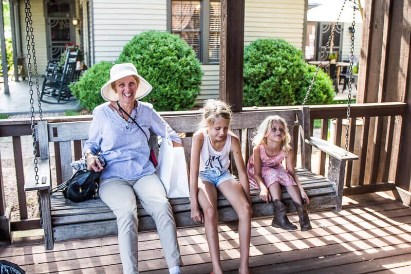 grandmother and two kids on porch chair