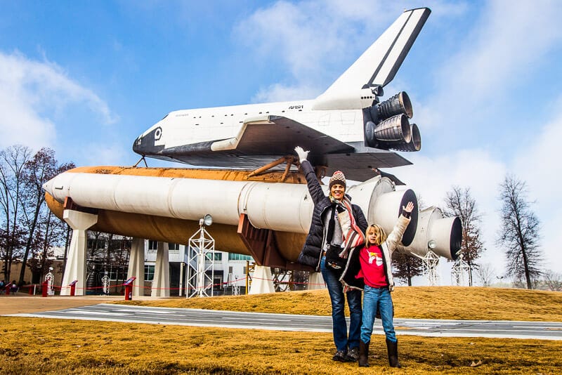 family posing in front of rocket US Space and Rocket Center Huntsville