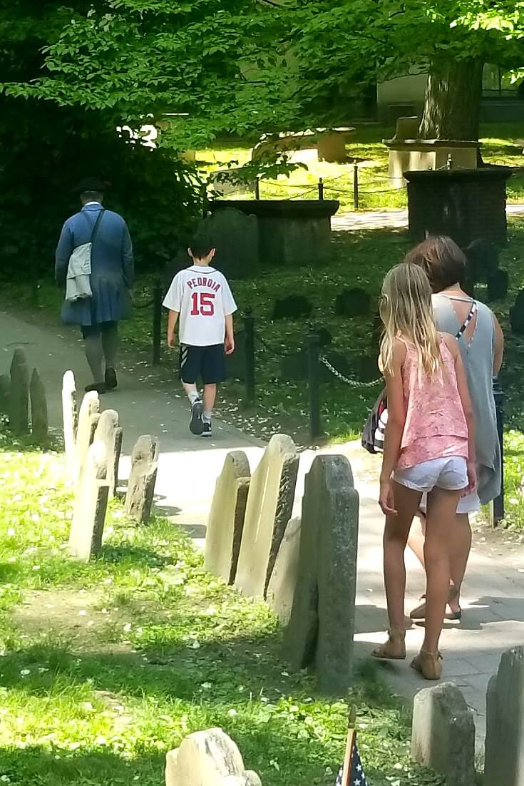 girls standing among gravestones in boston cemetary