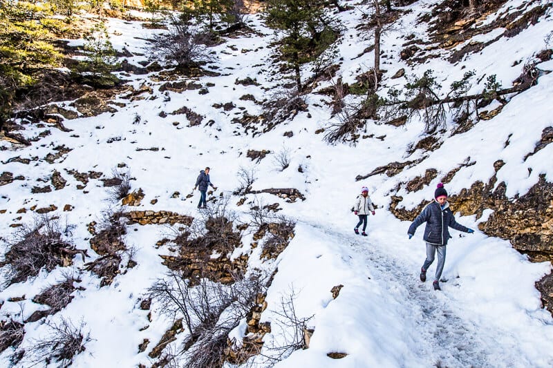 girls walking on bright angel trail covered in snow