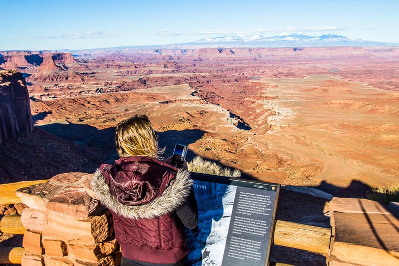 woman reading information board at canyonlands