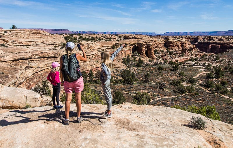 A group of people standing in a rocky area