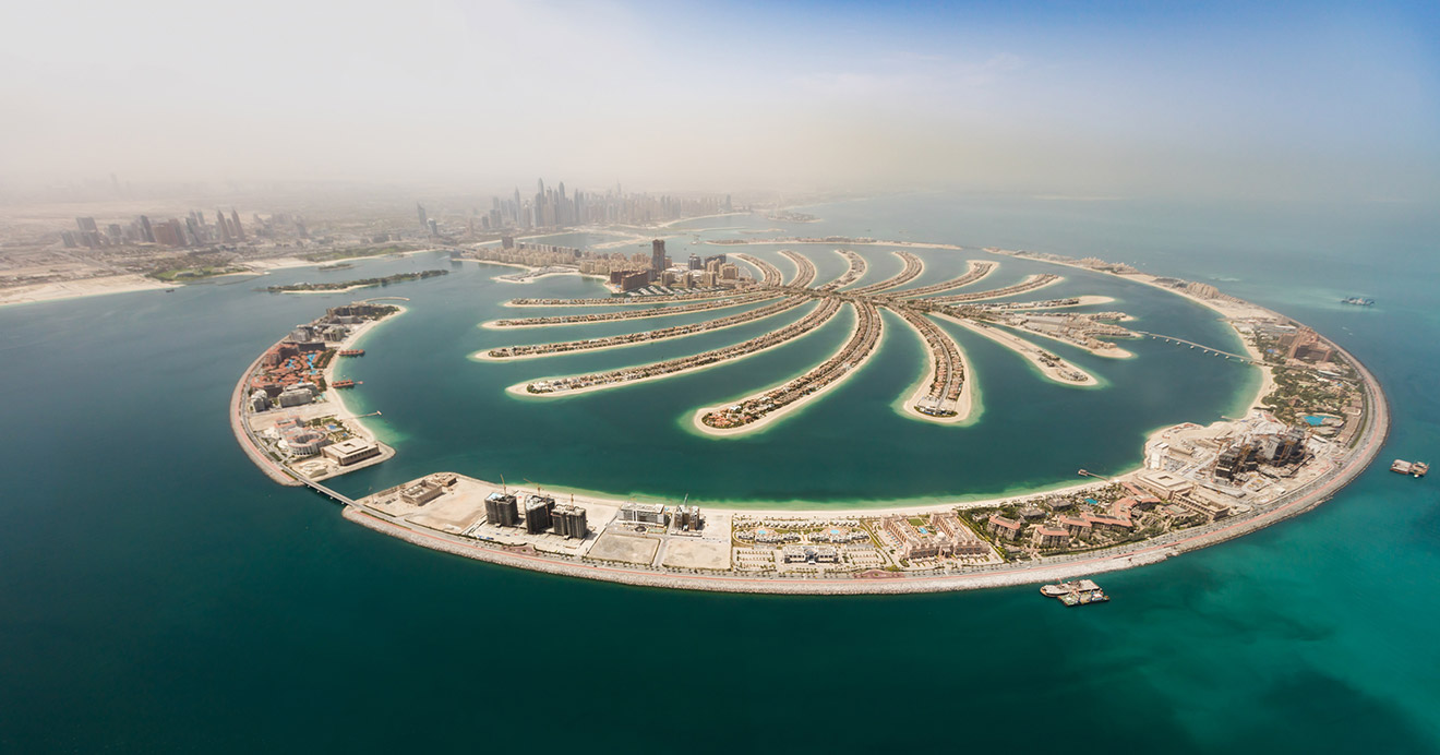 Aerial view of Palm Jumeirah in Dubai, showcasing its unique palm tree-shaped island design with luxury villas
