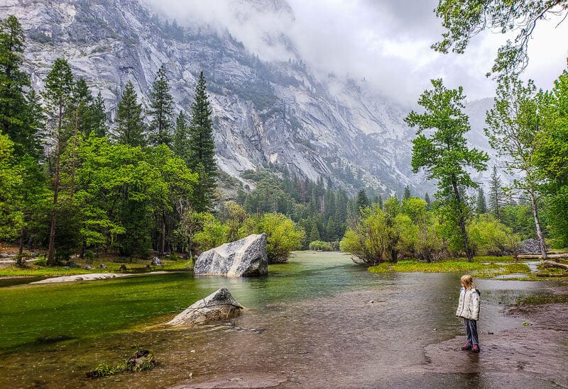 girl on trail looking at mirror lake