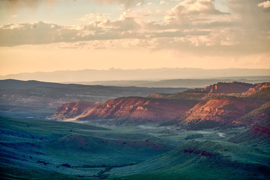 view of green valley and red mountains