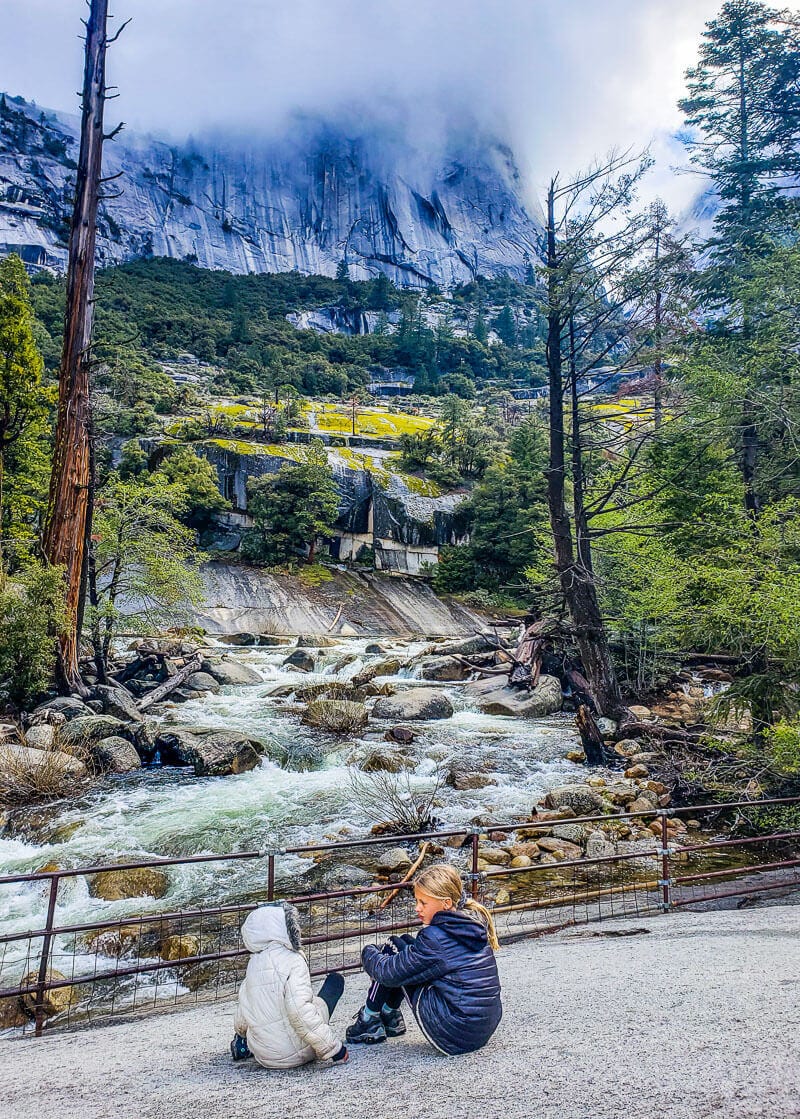 girl looking at rushing river in yosemite