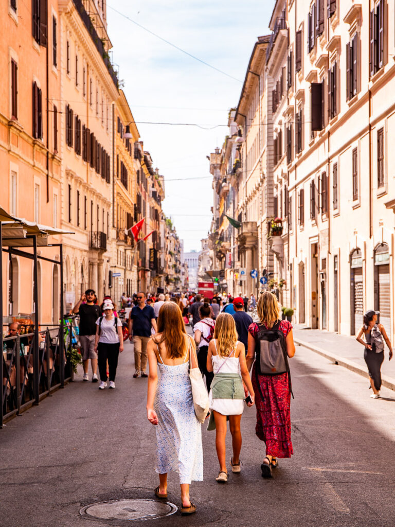 woman and girls walking along Via del Corso in rome