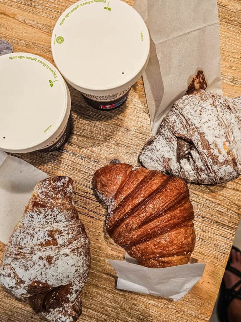 croissants and italian pastry with coffee on table