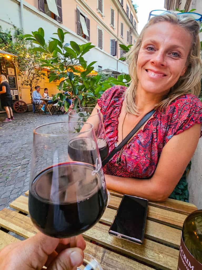 lady enjoying glass of red wine at table